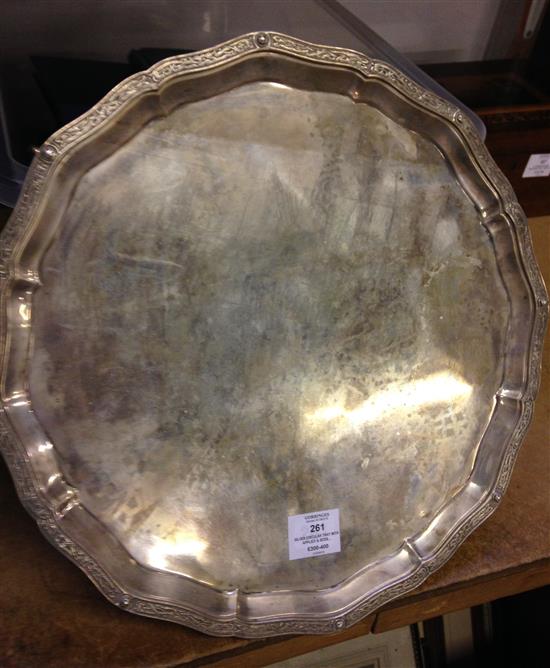 Silver circular tray with applied & boss decoration to wavy rim, four claw and ball feet, London 1930, Reid & Sons